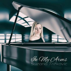 Album cover for "In My Arms" by Suzana Trifkovic, portrait of Suzana sitting behind grand piano