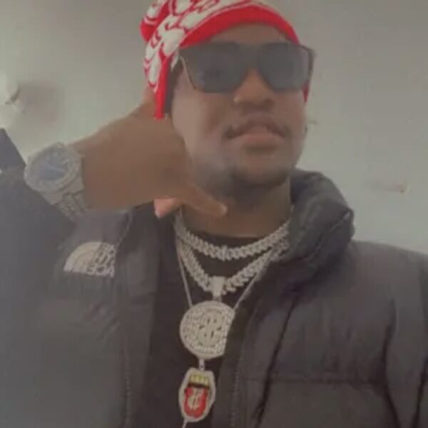 A cool profile picture of Lil Trophy wearing a red hat, a black Northface Jacket and three icy chains.